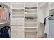 Neatly arranged walk-in closet with white shelving units, drawers, hanging space, and a wire storage basket at 4105 Gnarled Oaks Ln, Johns Island, SC 29455
