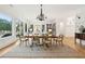 Open-concept dining area with view of the living room, built-in bookshelves and ample natural light at 4105 Gnarled Oaks Ln, Johns Island, SC 29455