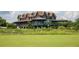 An expansive brick structure with covered verandas, showcasing classic architectural detailing and scenic views at 4105 Gnarled Oaks Ln, Johns Island, SC 29455