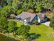 Beautiful home with a well-manicured lawn, mature trees, and outdoor seating at 4105 Gnarled Oaks Ln, Johns Island, SC 29455