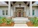 A welcoming front entrance with stone accents and mature landscaping at 4105 Gnarled Oaks Ln, Johns Island, SC 29455