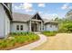 Inviting home featuring a covered porch and a manicured yard with fresh landscaping at 4105 Gnarled Oaks Ln, Johns Island, SC 29455