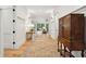 Inviting hallway with hardwood floors, white walls, and classic furnishings leading into a bright and airy living space at 4105 Gnarled Oaks Ln, Johns Island, SC 29455