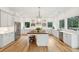 Bright, modern kitchen featuring white cabinetry, stainless steel appliances, and a large center island at 4105 Gnarled Oaks Ln, Johns Island, SC 29455