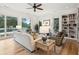 Bright living room featuring built-in bookshelves, comfortable seating, and scenic views of the outside landscape at 4105 Gnarled Oaks Ln, Johns Island, SC 29455