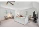 Large living room with neutral decor, ceiling fan, comfortable seating, and natural light from three windows at 4105 Gnarled Oaks Ln, Johns Island, SC 29455