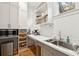 Modern pantry with sleek cabinetry, stainless steel sink, and open shelving at 4105 Gnarled Oaks Ln, Johns Island, SC 29455
