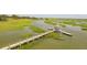 Picturesque pier extending into a marsh with a covered gazebo, perfect for relaxation and enjoying nature at 4105 Gnarled Oaks Ln, Johns Island, SC 29455