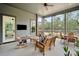 Charming sunroom equipped with a television and multiple places to sit and relax at 4105 Gnarled Oaks Ln, Johns Island, SC 29455