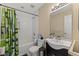 Bathroom features a shower and tub combination, a decorative shower curtain, and a black vanity at 47 Drake St, Charleston, SC 29403