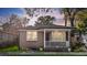 Charming brick home with a covered porch, lush landscaping, and warm, inviting curb appeal at 47 Drake St, Charleston, SC 29403