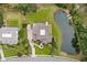 Stunning aerial view of a luxury home with a private pond and lush landscaping at 4935 Sound View Dr, Mount Pleasant, SC 29466