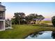 Expansive backyard with a tranquil pond, mature trees, and a scenic marsh view at 4935 Sound View Dr, Mount Pleasant, SC 29466