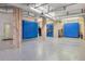 Spacious basement with blue epoxy floors, blue cabinets and tool storage at 4935 Sound View Dr, Mount Pleasant, SC 29466