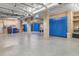Spacious basement with blue epoxy floors, blue cabinets, storage, and utility hookups at 4935 Sound View Dr, Mount Pleasant, SC 29466