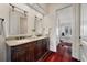 Elegant bathroom features a double vanity with granite countertop and wood cabinetry at 4935 Sound View Dr, Mount Pleasant, SC 29466