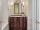 Elegant powder room features a custom vanity with granite countertop, decorative mirror and sconces at 4935 Sound View Dr, Mount Pleasant, SC 29466