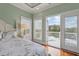 This bedroom features hardwood floors, double windows, and access to the balcony at 4935 Sound View Dr, Mount Pleasant, SC 29466