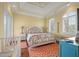 Bright bedroom with vibrant decor, hardwood floors, tray ceiling, and large windows for natural light at 4935 Sound View Dr, Mount Pleasant, SC 29466