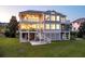 Three-story house with balconies and a screened-in porch on a sprawling lawn at 4935 Sound View Dr, Mount Pleasant, SC 29466