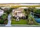 Stunning waterfront home boasts lush landscaping, grand entrance, and elegant architectural details at 4935 Sound View Dr, Mount Pleasant, SC 29466