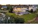 Aerial view of a grand three-story home with balconies and screened porches, overlooking a pond at 4935 Sound View Dr, Mount Pleasant, SC 29466