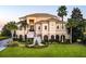 Beautiful home featuring manicured lawn, stately palm trees, and classic architectural elements at 4935 Sound View Dr, Mount Pleasant, SC 29466