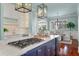 Elegant kitchen with a large island, gas cooktop, white cabinets, and open to the dining area at 4935 Sound View Dr, Mount Pleasant, SC 29466