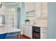 Kitchenette featuring white cabinets, wine cooler, and modern fixtures near an arched doorway at 4935 Sound View Dr, Mount Pleasant, SC 29466