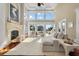 Elegant living room with high ceilings, large windows, fireplace and marsh views at 4935 Sound View Dr, Mount Pleasant, SC 29466