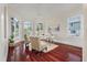 Comfortable home office featuring three arched windows and cherry wood floors at 4935 Sound View Dr, Mount Pleasant, SC 29466