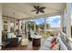 Cozy screened porch with comfortable furniture and a relaxing view of the water at 4935 Sound View Dr, Mount Pleasant, SC 29466