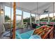 Inviting screened porch featuring a swing bed, comfortable seating, and waterfront views at 4935 Sound View Dr, Mount Pleasant, SC 29466