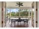 Inviting screened porch with outdoor dining set overlooking scenic water views at 4935 Sound View Dr, Mount Pleasant, SC 29466