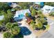 Aerial view of a blue beach house surrounded by palm trees in a sunny neighborhood at 5 25Th Ave, Isle of Palms, SC 29451
