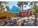 View of the backyard, showcasing the elevated deck, stairs, and a stone fire pit area at 5 25Th Ave, Isle of Palms, SC 29451