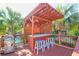 Outdoor covered bar featuring a marble countertop, four colorful stools, and a stainless steel grill at 5 25Th Ave, Isle of Palms, SC 29451