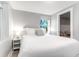 Inviting bedroom with soft lighting, a plush bed, side tables, and a beach-themed decorative pillow at 5 25Th Ave, Isle of Palms, SC 29451