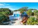 Beautiful blue home with a metal roof, garage, wooden stairs, and a screened-in porch at 5 25Th Ave, Isle of Palms, SC 29451