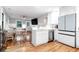 Modern kitchen overlooking the dining and living areas, featuring stainless steel appliances and hardwood floors at 5 25Th Ave, Isle of Palms, SC 29451
