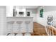 Stylish kitchen with bar seating, stainless steel appliances, and shiplap walls blending modern design at 5 25Th Ave, Isle of Palms, SC 29451