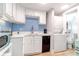 Bright kitchen with white cabinetry, blue backsplash, and modern appliances including a dishwasher at 5 25Th Ave, Isle of Palms, SC 29451