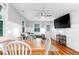 Open concept living and dining area with hardwood floors, a ceiling fan, and ample natural light at 5 25Th Ave, Isle of Palms, SC 29451