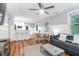 Open-concept living room boasts shiplap walls, wood floors, and modern furnishings at 5 25Th Ave, Isle of Palms, SC 29451