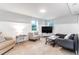 Living room featuring neutral walls, plank accent wall, tile floors, and a comfortable seating area at 5 25Th Ave, Isle of Palms, SC 29451