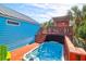 Backyard with a jacuzzi and outdoor seating area under a pergola at 5 25Th Ave, Isle of Palms, SC 29451