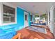 A bright, breezy porch with a porch swing and comfortable blue and orange seating at 5 25Th Ave, Isle of Palms, SC 29451