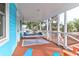 Spacious screened porch with comfortable porch swing and seating area with cozy decorations at 5 25Th Ave, Isle of Palms, SC 29451