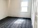 Bright bedroom with a large window, white walls, and a patterned carpet at 5056 Butler St, North Charleston, SC 29406