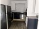 Kitchen with modern appliances, dark cabinets, and laminate flooring at 5056 Butler St, North Charleston, SC 29406